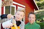 Two brothers pouring fresh orange juice to sell at roadside