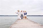 Group of friends walking on pier