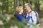 Couple standing face to face in forest