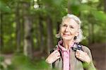 Portrait of senior woman standing in forest