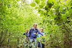 Group of friends, hiking through forest