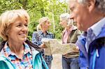 Group of friends on hiking trail, looking at map