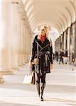 Stylish young woman carrying shopping bags, Covent Garden, London, UK