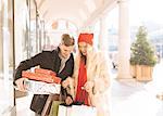 Young couple looking at xmas gifts in Covent Garden, London, UK