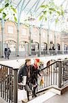 Young shopping couple on stairway in Covent Garden, London, UK