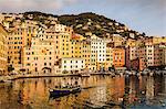 Elevated view of fishing boat leaving the harbor, Camogli, Liguria,  Italy