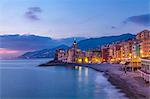 View of beach and hotels at dusk, Camogli, Liguria,  Italy