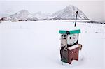 Old gas pump in snow covered landscape, Noss, Lofoten Islands, Norway