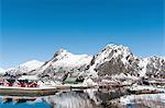 Waterfront houses and snow capped mountain, Svolvaer, Lofoten Islands, Norway