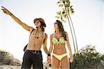 Young couple pointing from Newport Beach, California, USA