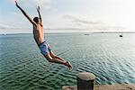 Boy jumping into water