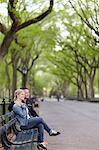 Smiling couple sitting on bench in park