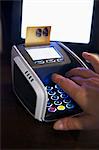 Hand putting bank card into card reader