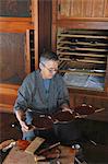 Japanese lacquer artisan working in the studio