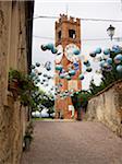Globe Balloons hanging over Streets with Torre dei Bressani, Mondovi, Piedmont, Italy