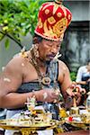 Hindu priest at a cremation ceremony for a high priest in Ubud, Bali, Indonesia