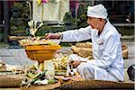 Hindu priest at a Bulan Pitung Dina (One Month and One Week) purification ceremony for baby and parents, Ubud, Bali, Indonesia