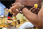 Close-up of hands of Hindu priest at a cremation ceremony for a high priest in Ubud, Bali, Indonesia