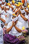 People praying at a cremation ceremony for a high priest in Ubud, Bali, Indonesia