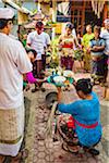 Woman holdng religious offering at Balinese wedding, Petulu Village near Ubud, Bali, Indonesia