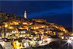 Overview of Sassi di Matera at night with the cathedral bell tower, one of the three oldest cities in the world, Basilicata, Italy