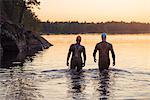 People in water at sunset