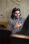 Young man in cafe listening music