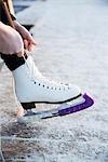 Woman putting ice skate on