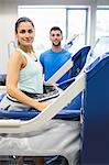 Woman using an anti gravity treadmill beside trainer