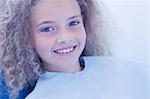 Smiling young patient sitting in dentists chair