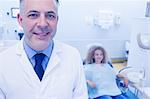 Pediatric dentist and little girl smiling at the camera