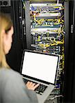 Technician using laptop to analyse server