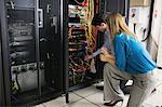 Technician looking at open server locker