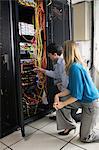 Technicians looking at open server locker