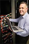 Technician looking at open server locker