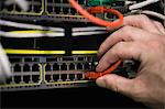 Technician inserting wire to server