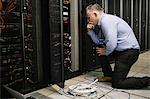 Technician working on broken server