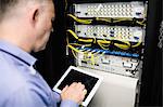 Technician looking at open server locker