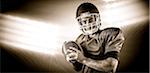 Composite image of portrait of american football player being about to throw football