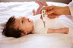 Pediatrician checking newborn temperature