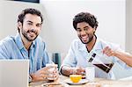 Happy gay couple having breakfast