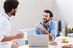 Happy gay couple using laptop