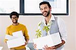 Happy gay couple holding white boxes