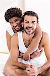 Portrait of smiling gay couple hugging