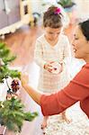 Mother and daughter decorating Christmas tree