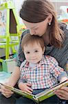 Mother reading to son at home