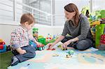 Mother playing with son at home