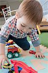 Baby boy playing with toys at home