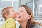 Baby boy kissing mother's cheek