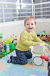 Baby boy stacking playing blocks at home